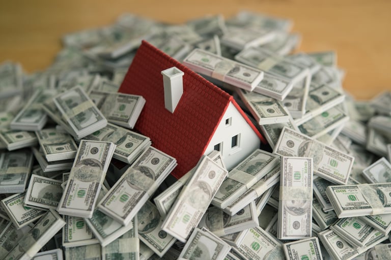 A house drowning in heap US dollar banknotes representing financial stress